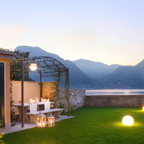 Dine under the pergola with loved ones, as you drink in the lake views