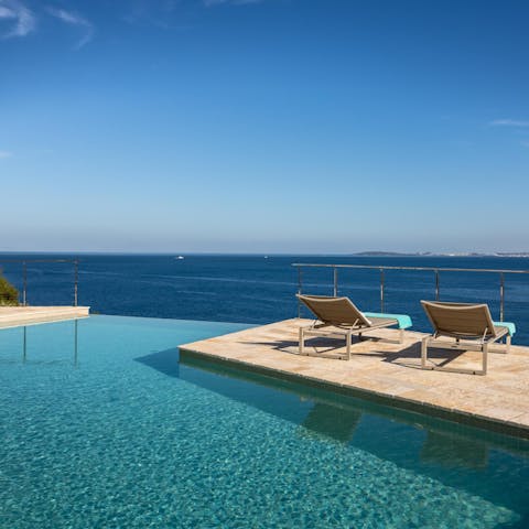 Watch the waves roll in from a poolside lounger