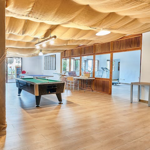 The villa is equipped with everything guests need for a comfortable stay, including a fully-equipped kitchen, a games room, and a gym.