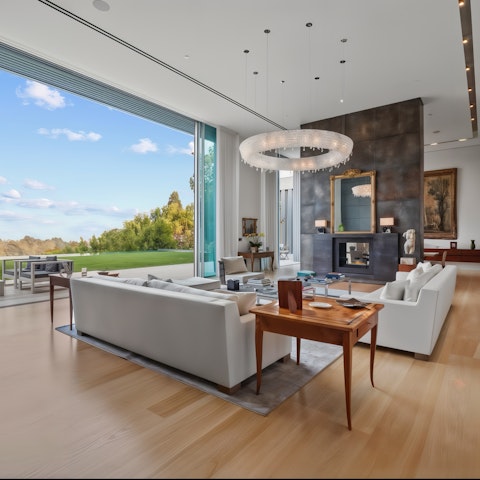 Open the floor-to-ceiling glass doors to blend the indoor and outdoor living spaces