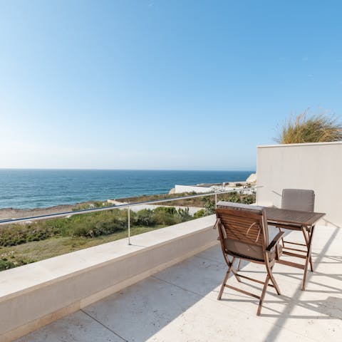 Sip a fresh juice from the balcony overlooking the waves