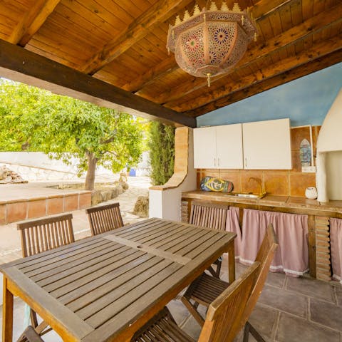 Try your hand at cooking some local dishes, then dine alfresco under the pergola