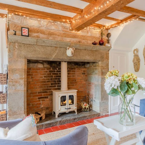 Snuggle up by the wood burning stove in the fairy light strewn study