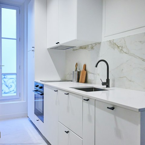 Prepare coffee and croissants in the sleek kitchen to start the day