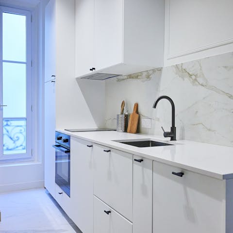 Prepare coffee and croissants in the sleek kitchen to start the day