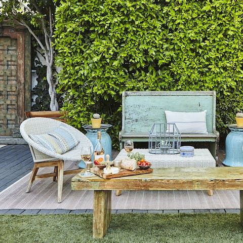 Open a bottle of wine to enjoy on the shabby chic patio set