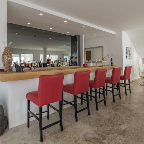 Have a well-deserved glass of red at the fully-stocked private indoor bar to end a long day