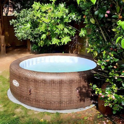 Unwind in the hot tub in the pretty garden