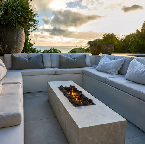 Gather around the fire pit overlooking the sea