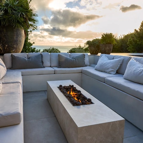 Gather around the fire pit overlooking the sea