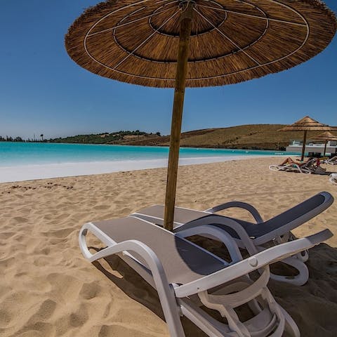 Relax on a sun lounger by the complex's private lagoon