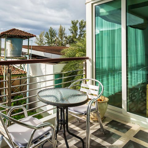 Enjoy a cool drink on your private balcony