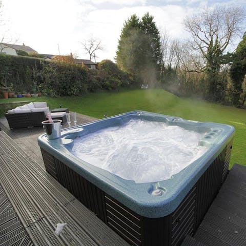 Sink into the warming hot tub with a glass or two of bubbly