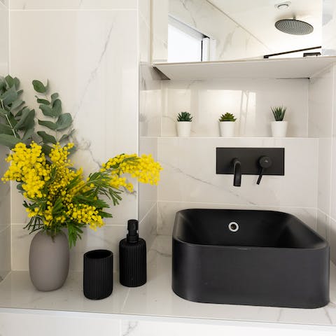 Start mornings off with a luxurious soak under the marble bathroom's rainfall shower