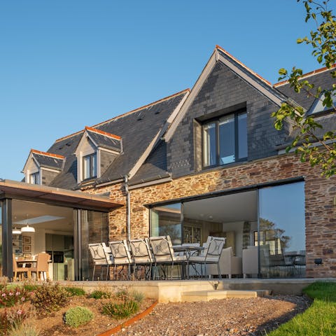 Enjoy outdoor dining on the terrace as the sun sets over the sea