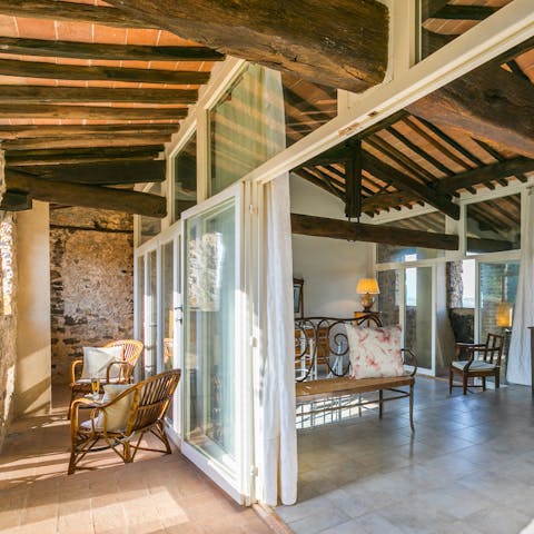 Relax on the main bedroom's private balcony with a glass of Prosecco