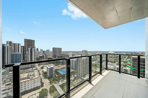 Sip a drink on the private balcony with the Miami skyline as a backdrop