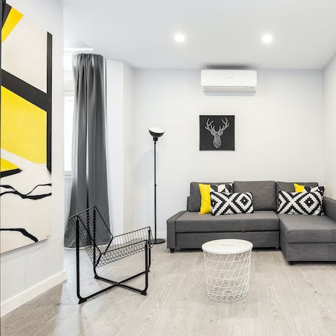 Relax on the sofa after a busy day exploring and admire the bold yellow artwork