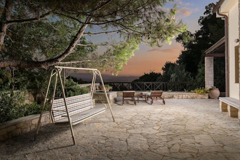 Settle down on the swing seat to while away the hours with a book