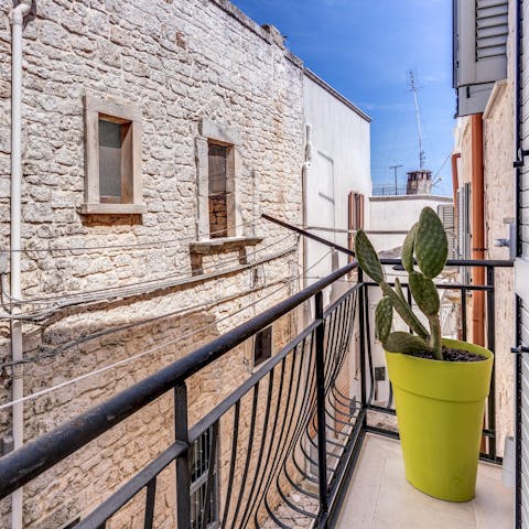 Peer out onto Ceglie Messapica's street life from the charming balcony