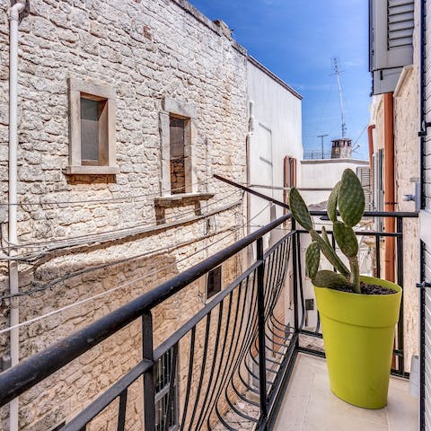 Peer out onto Ceglie Messapica's street life from the charming balcony