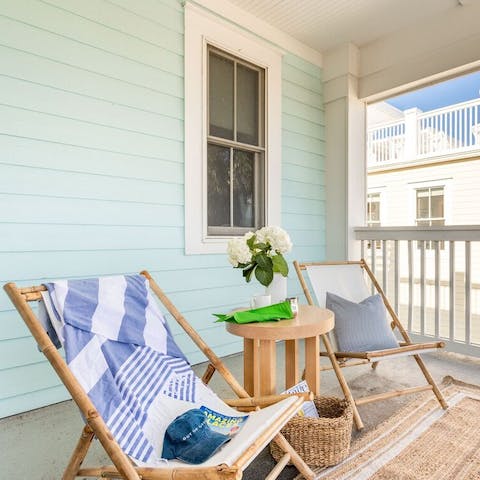 Relax under the sun on the balcony's deck chairs