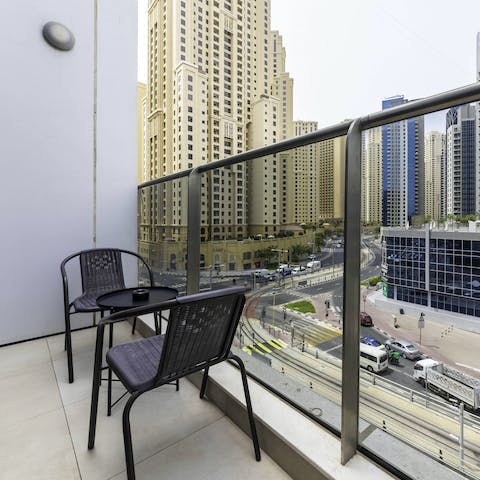 Watch the city come to life from your private balcony on high