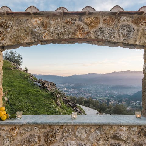 Admire the countryside and sea views through the mellow stone arch