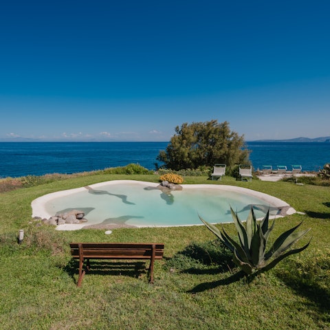 Admire sea views as you swim in the private pool