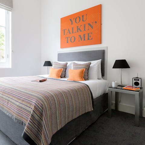 Sleep well in the comfortable bed, nodding off underneath some bright orange artwork