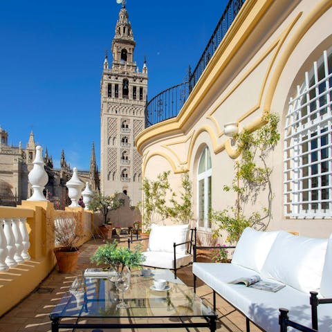 Relax on the stunning terrace overlooking Seville Cathedral and the Giralda