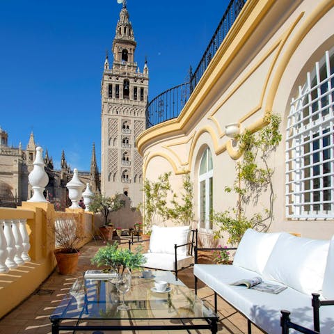 Relax on the stunning terrace overlooking Seville Cathedral and the Giralda