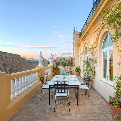 Dine outside on the terrace that wraps around the apartment