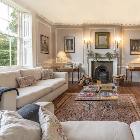 Gather around the open fire in the drawing room