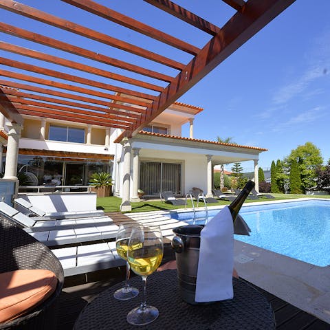 Grab a glass of something cold and secure a spot by the pool