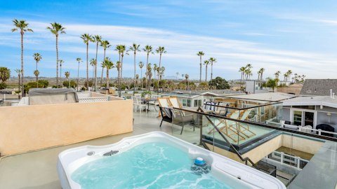 Relax and unwind in the private hot tub with sea views