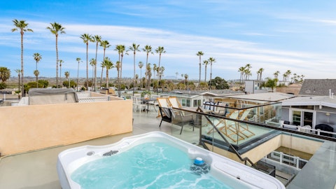 Relax and unwind in the private hot tub with sea views