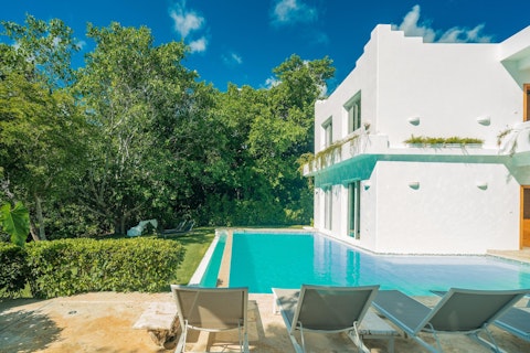 Cool off in the pool backed by lush tropical greenery