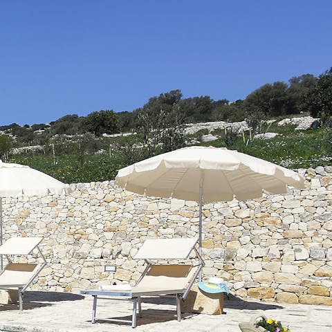 Soak up the Sicilian sunshine from the poolside loungers