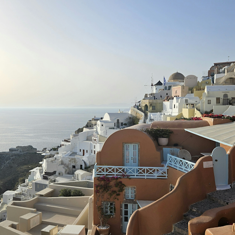Take the ten-minute drive to Fira and weave through the narrow streets