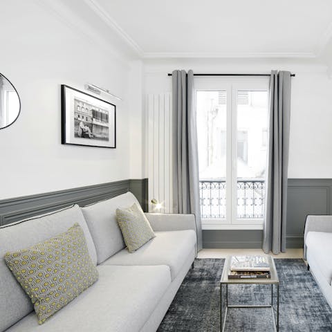 Enjoy a glass of wine and some people-watching by the living room's Juliet balcony