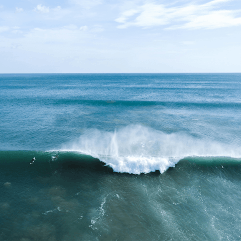 Catch some waves at the resort's beach, five minutes away