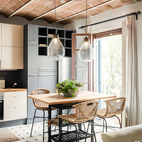 Sit down to a meal in the kitchen while feasting on Gràcia views from the Juliet balcony