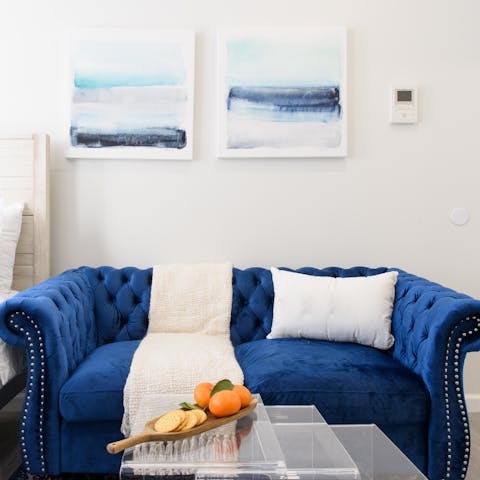 Kick back on the plush sapphire-coloured sofa with a glass of wine after a day of Manhattan exploring
