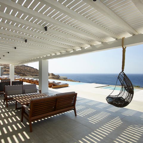 Choose between the egg-chair or a sofa in the shaded lounge