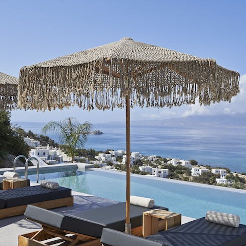 Swim laps in the infinity pool and dry off on a lounger
