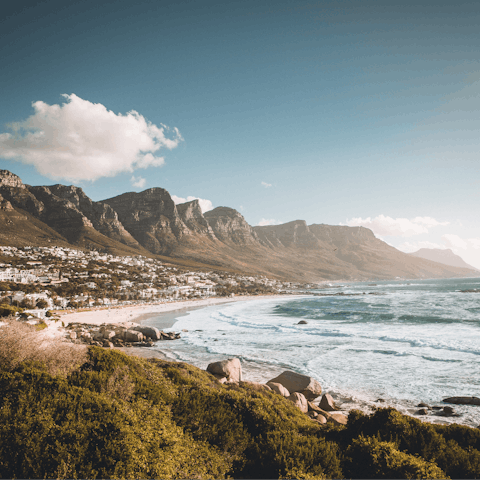 Make the fifteen-minute drive over to Camps Bay Beach and swim in the Atlantic Ocean