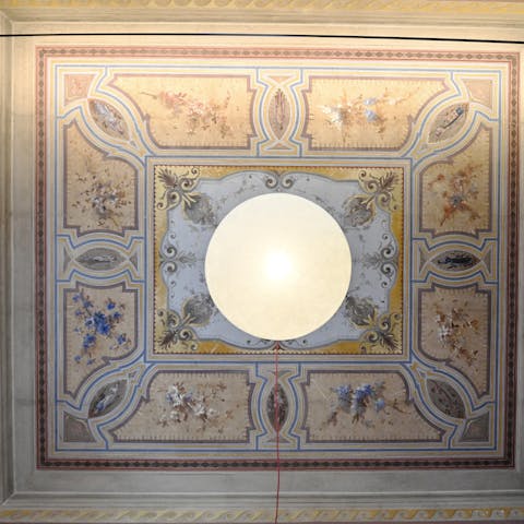 Admire frescoed ceilings in this elegant apartment