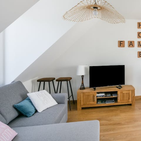 Relax and unwind in the bright living room, enjoying a glass of wine and a movie