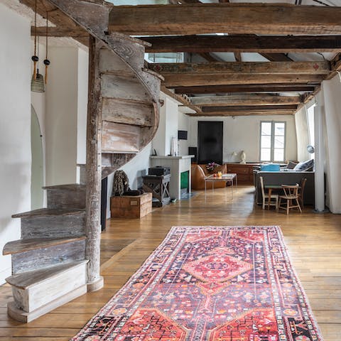 Head up the original, wooden spiral staircase above the rustic beams